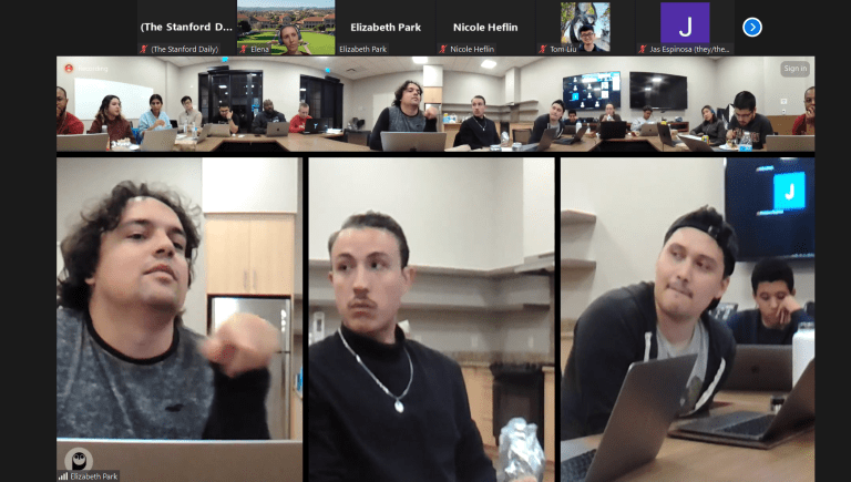 Screenshot of Zoom meeting with people sitting around desk