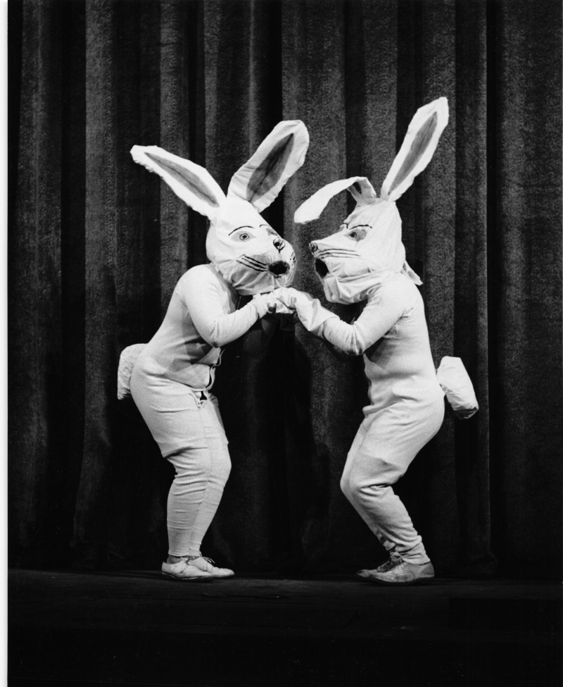 two people onstage in handmake-looking white rabbit costumes