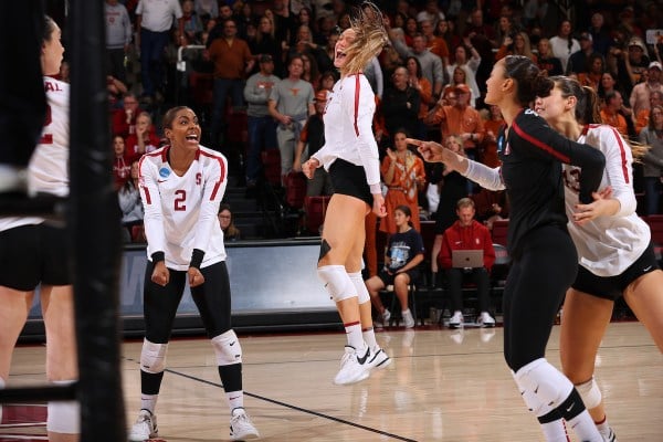 Fifth-year opposite Kendall Kipp, junior setter Kami Miner and libero Elena Oglive celebrate a point against Texas. (Photo: Mike Rasay/ISI Photos)