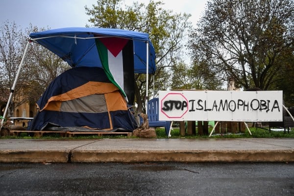 Blue tent next to table reading "Stop Islamophobia"