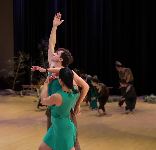 Photo of two dancers from Chocolate Heads, wearing green.