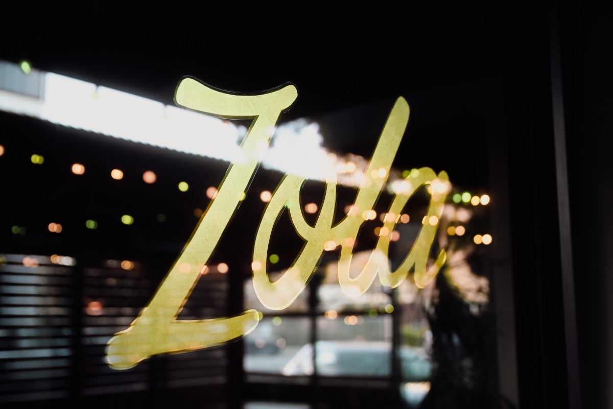 A window with "Zola" written on it in gold text.