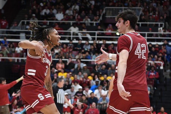 Junior and forward Maxime Raynaud celebrates with freshman and guard Kanaan Carlyle during Stanford's dominant 99-68 win over USC. (Photo: Michael Kheir/The Stanford Daily)