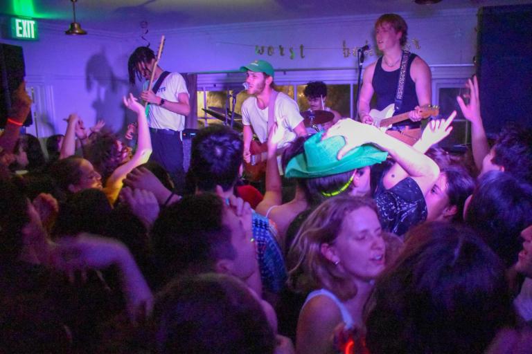 Purple lighting shines upon Banana Bred as they perform at 650 Mayfield in front of a crowd of students during Lover's Rock.