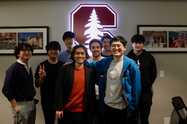 Stanford Smash Bros. Standing in front of Stanford logo.
