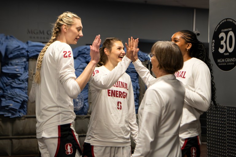 Cameron brink, Hannah Jump, Tara VanDerveer and Kiki Iriafen greet each other before a game.