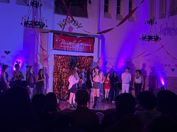 Singers in trendy Valentine's Day themed outfits perform in Toyon Hall.