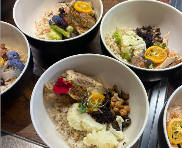 Photo of bowls of food, with rice, chicken and cauliflower. This was one of the campus dining options from family weekend.