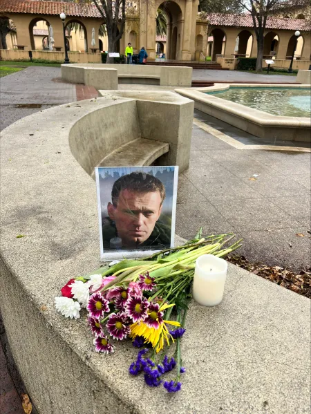 Photo of Navalny placed alongside a bouquet of flowers at White Plaza.