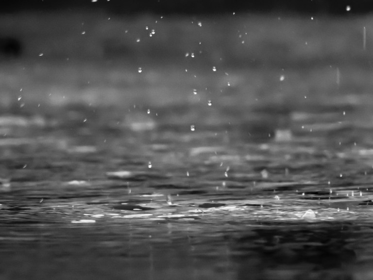 A grayscale image of rain falling.