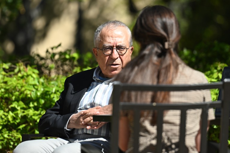 Fayyad sits across from a Daily reporter who is turned away from the camera.