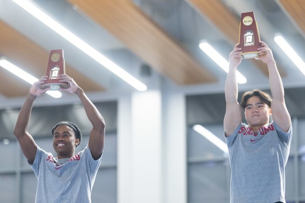 Khoi Young and Asher Hong raise their trophies.