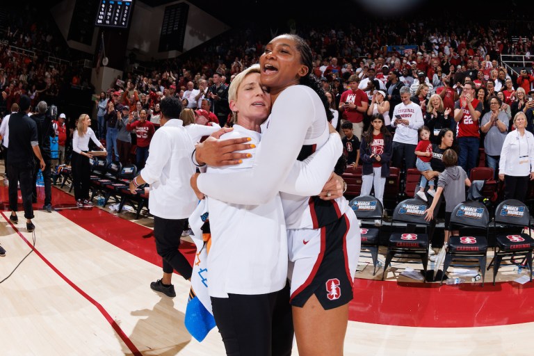 Kate Paye and Kiki Iriafen embrace.