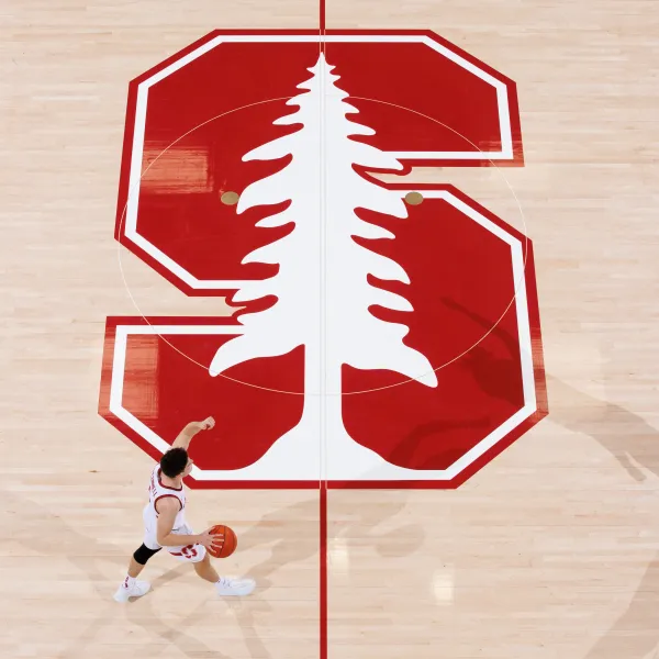 Stanford Basketball player dribbles the ball on the court during a game in Maples Pavilion