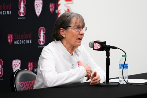 Tara VanDerveer speaks at a press conference with a microphone in front of her.