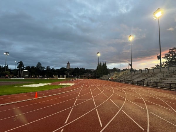 An image of an outdoor sports track in the evening.