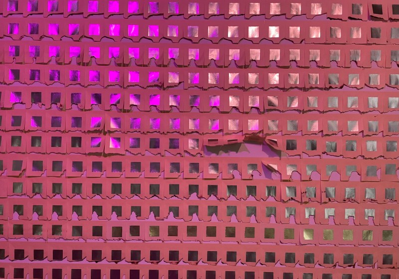 a wall art display, featuring texture tiles and pink luminescent lighting.