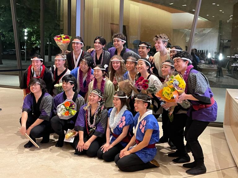 A photo of the members of Stanford Taiko in concert attire after their performance.