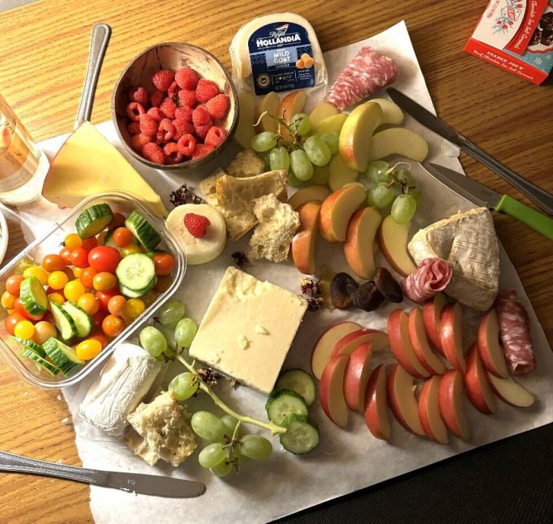 A charcuterie board with many different kinds of cheese