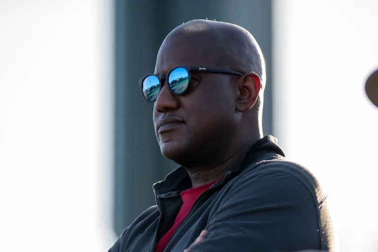 Bernard Muir watches softball game between Stanford and Cal State Fullerton.