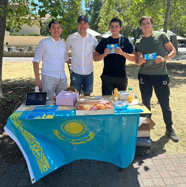 Members of The Central Asian Student Association stand behind their fundraising table