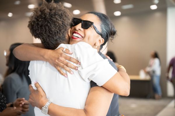 Two women hug at a Juneteenth event hosted at Stanford.