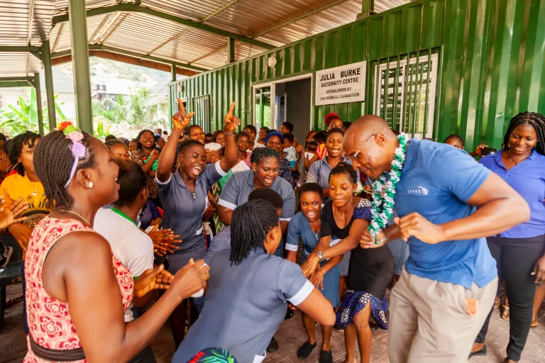 Afam Onyema stands in front of a room of people as part of his medical and educational nonprofit in Nigeria