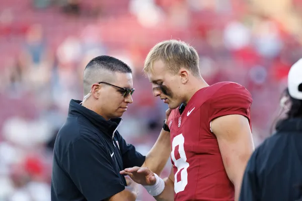 Jacob Callahan meets with Justin Lamson on the sideline.