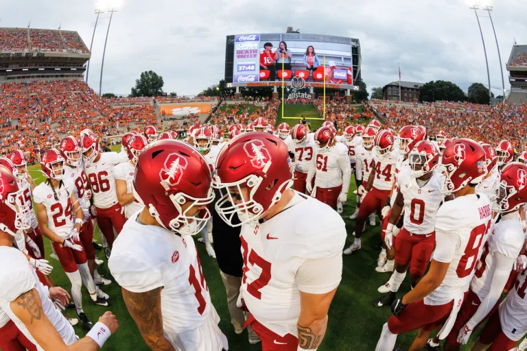 Stanford football players gather in pre-game huddle