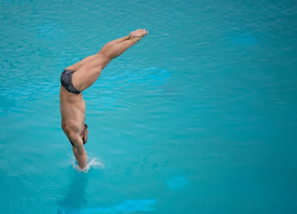 Hunter Hollenbeck competes during a swim and dive meet.