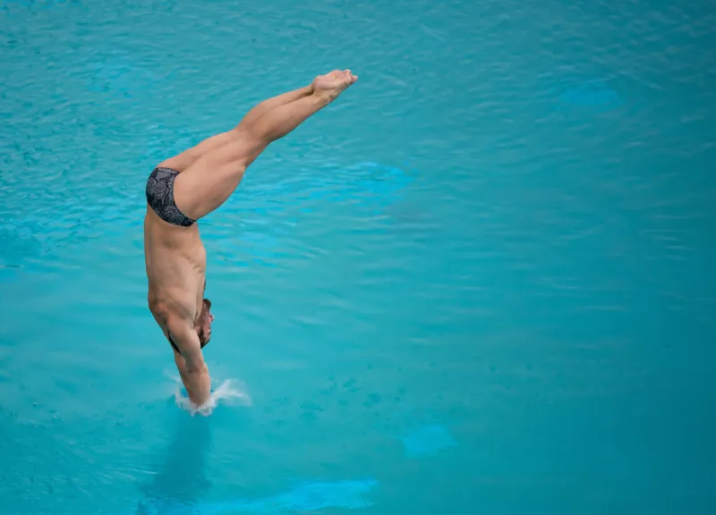 Hunter Hollenbeck competes during a swim and dive meet.