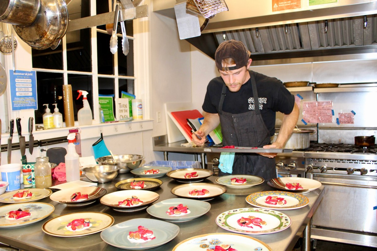 Kirchenbauer working in the chef with all the salmon plates in front of him about to go out.