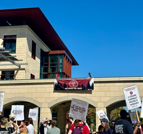 A group of Stanford graduate workers in front of Engineering Quad.