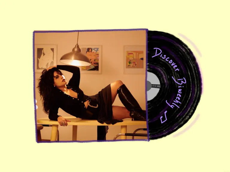 Photo of Girl Ultra lying across a table as an album cover with a disc sticking out of it reading "Discover Biweekly."