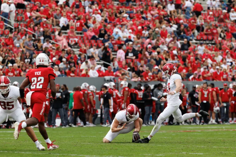 Kicker Emmet Kenney attempts a field gaol against North Carolina State University.