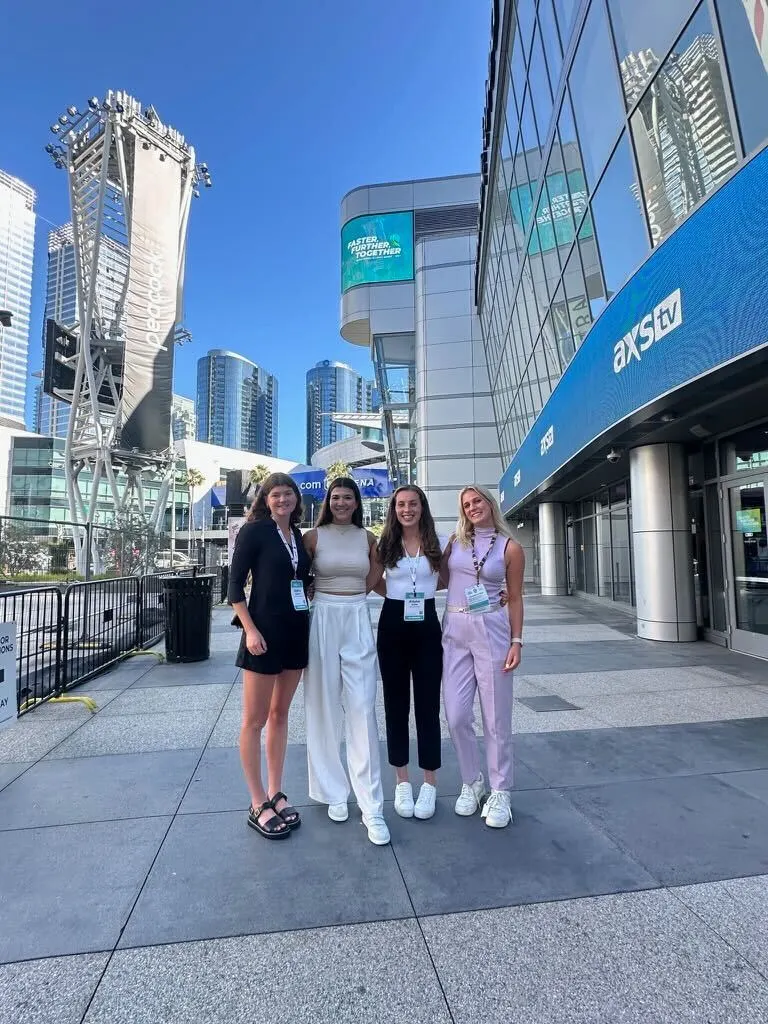 Student athletes standing outside of a conference.