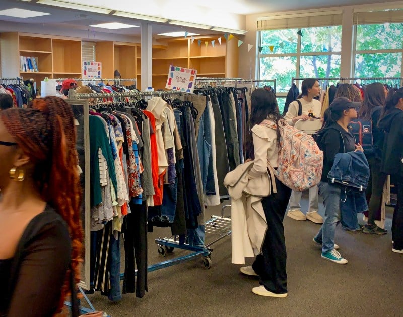 Students check out racks full of clothing at Career Closet.