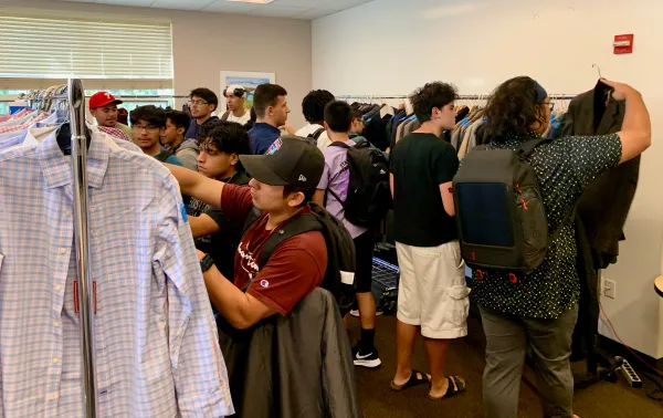 Students browsing through professional clothes.