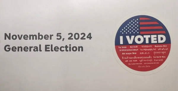 Piece of paper reading "November 5, 2024 General Election." There is an "I Voted" sticker attached.