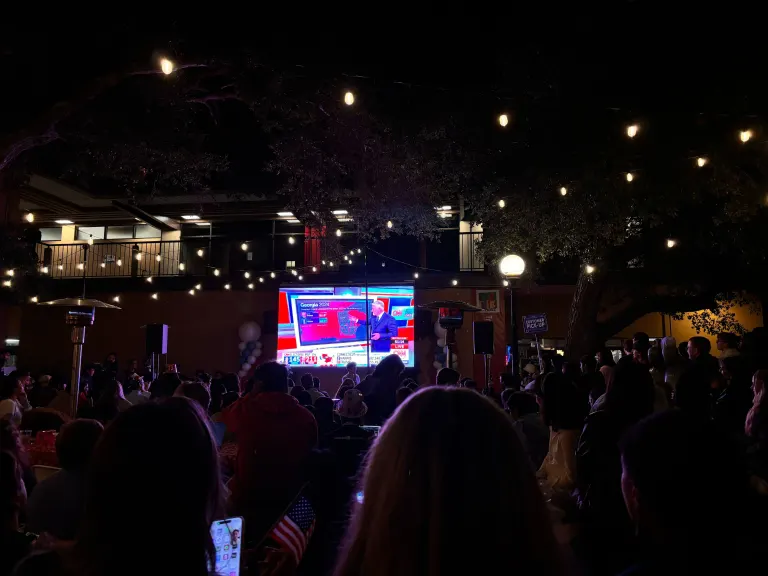 students watch election results on CNN at the arbor