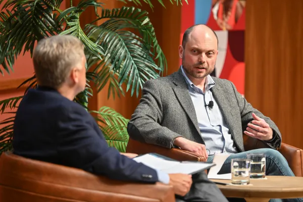 Vladimir Kara-Murza sitting onstage and speaking.