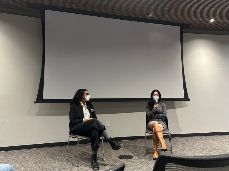 Rucy Cui and D.M. Spratley sit side by side on stage, speaking into microphones.