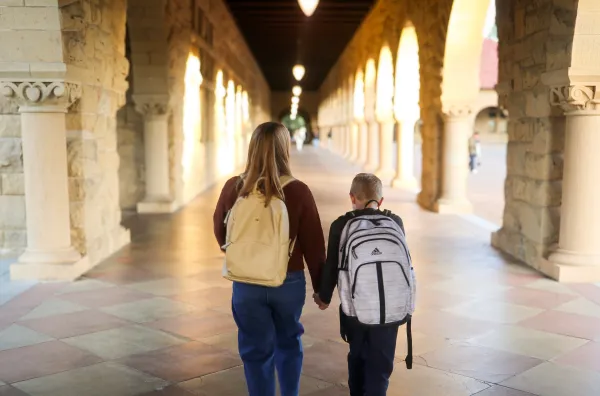 The backs of Carla Galaise and her ten year-old son, Eli, walking down the arcades.