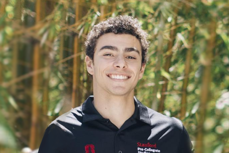 Luigi Mangione wearing a Stanford Pre-College Studies staff shirt.