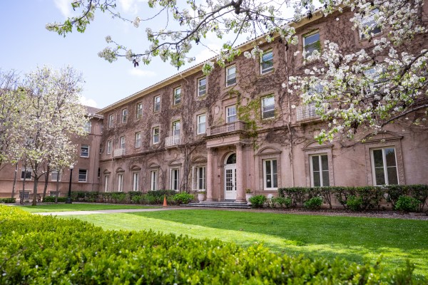 Exterior of Roble Hall with flowering trees in the spring.