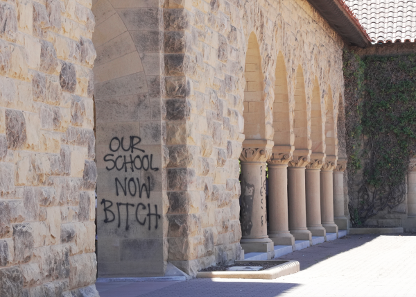 Graffiti reading "Our school now bitch" covers a pillar in Main Quad.