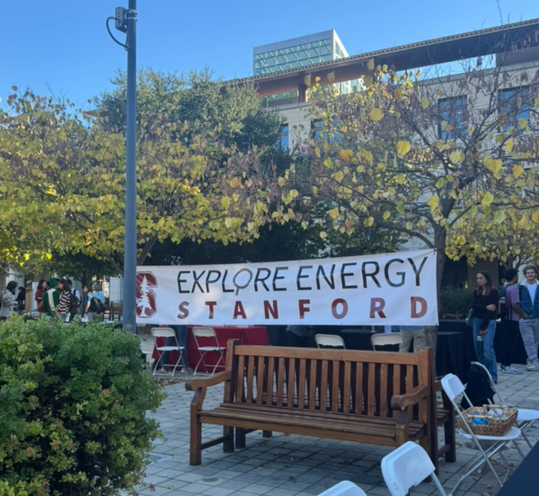 A banner titled, "Explore Energy Stanford" in front of a bench.