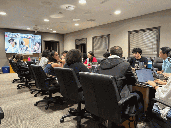 The Undergraduate Senate convening around a conference table for its weekly meeting.