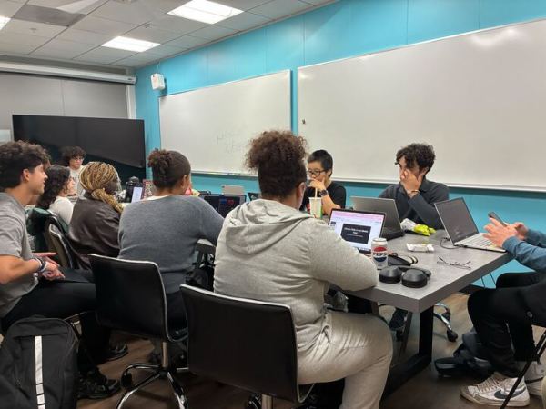 UGS senators sitting around a table for their weekly Wednesday meeting.