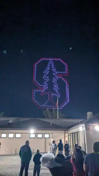 Drones depicting the Stanford logo in the night sky